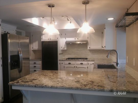 812 Bryann Street Ridgecrest, CA 93555 - Photo 5 of 34 a kitchen with kitchen island a counter a refrigerator and a sink