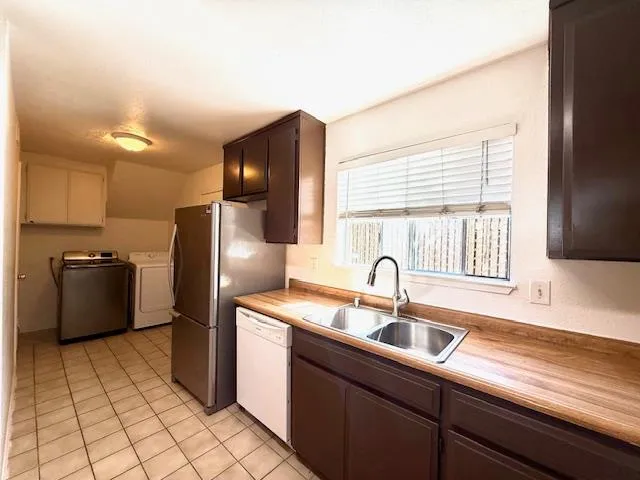 a kitchen with a sink cabinets and stainless steel appliances