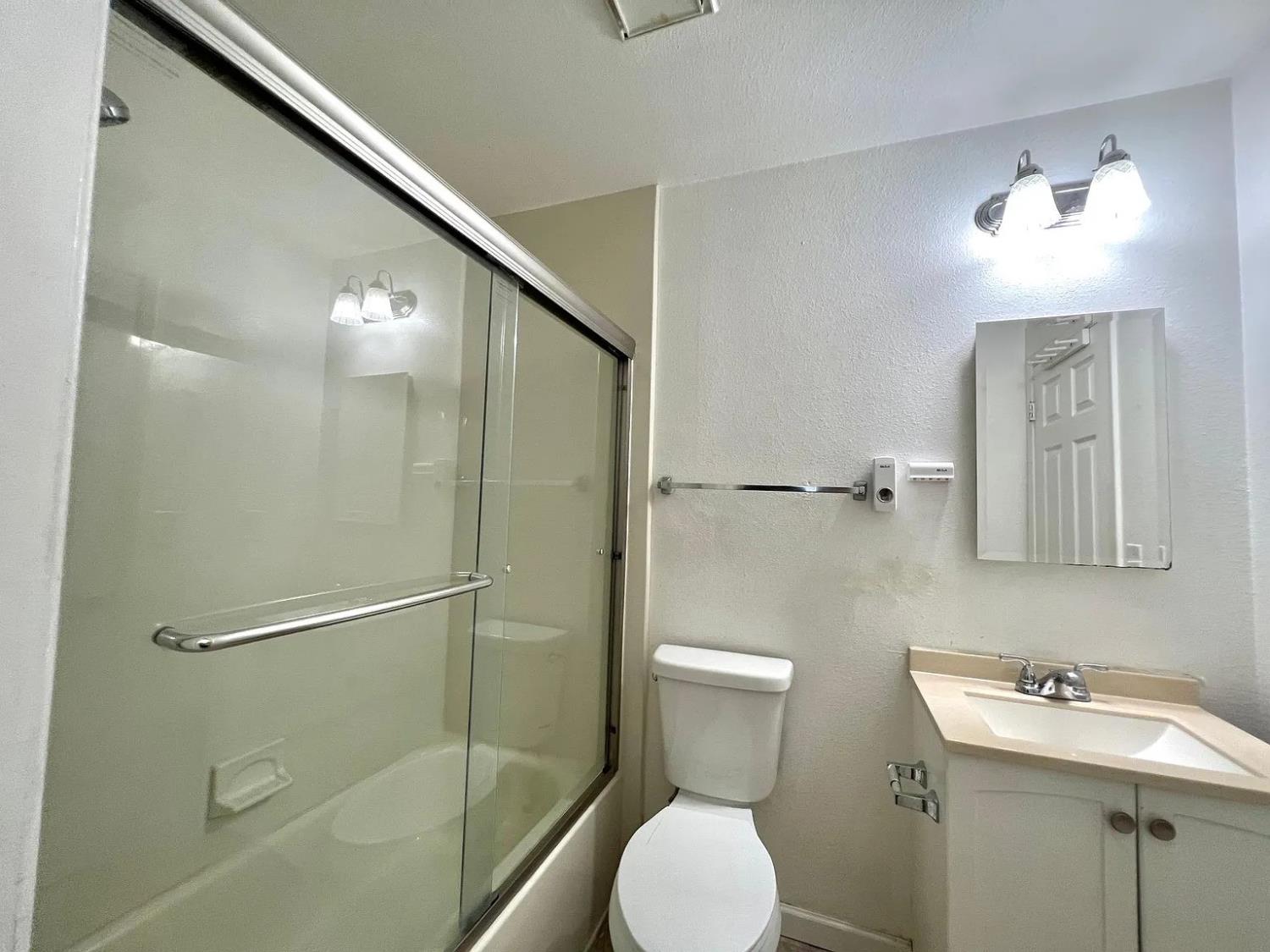 80 East Portola Way, Unit 105 Tracy, CA 95376 - Photo 9 of 12 a bathroom with a toilet sink and shower