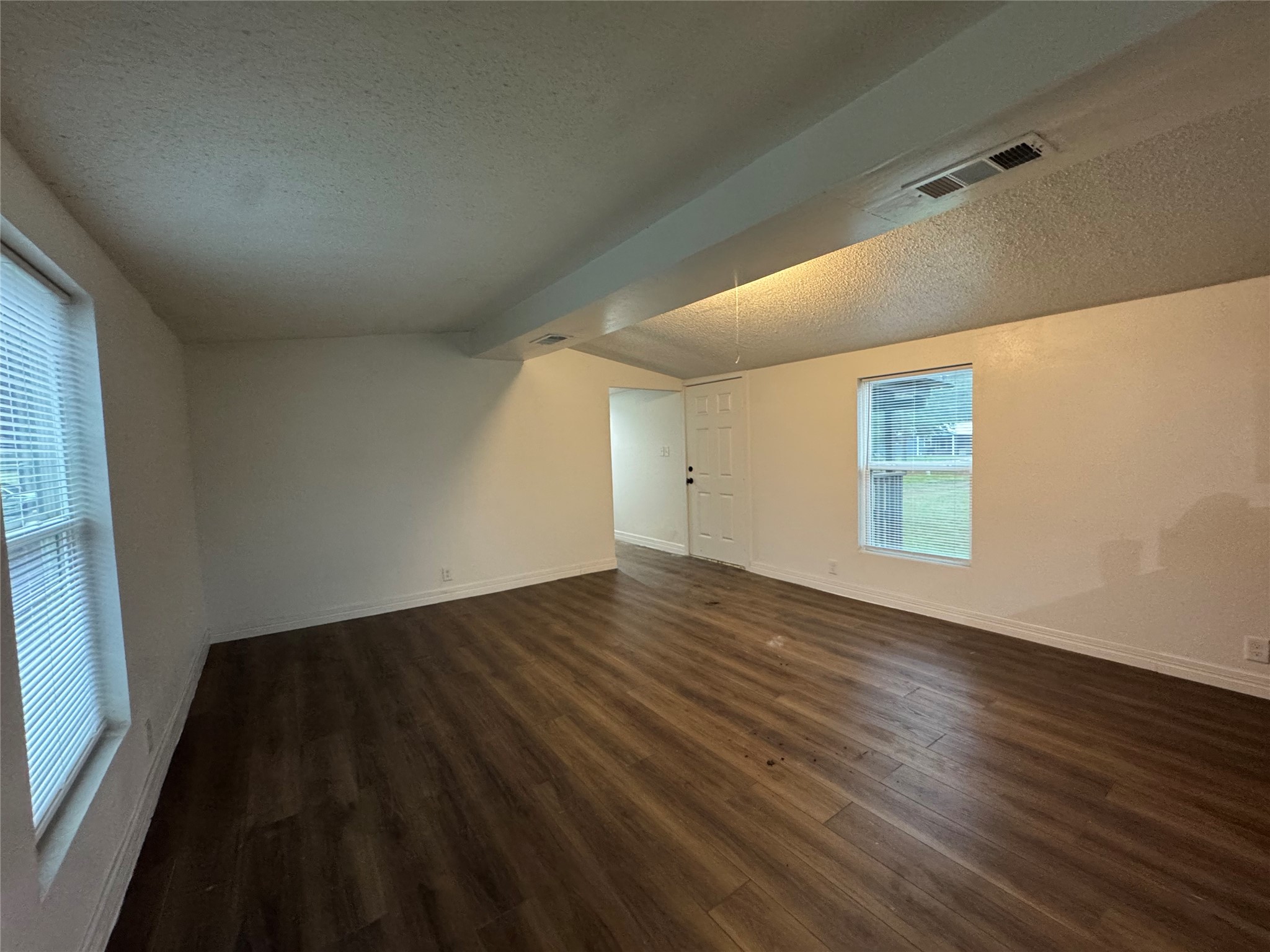 19307 Timberland Boulevard Porter, TX 77365 - Photo 2 of 9 an empty room with wooden floor and windows