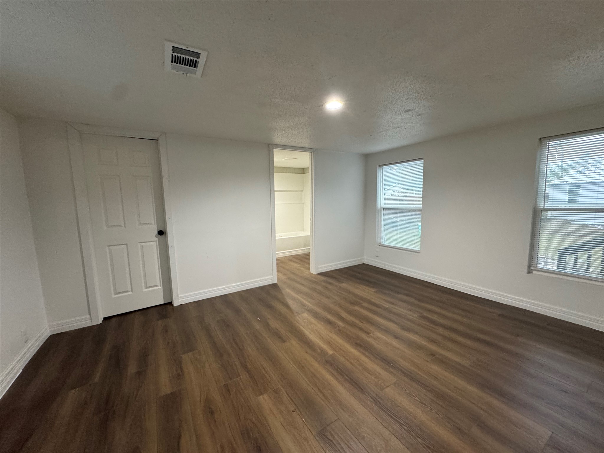19307 Timberland Boulevard Porter, TX 77365 - Photo 7 of 9 a view of an empty room with wooden floor and a window