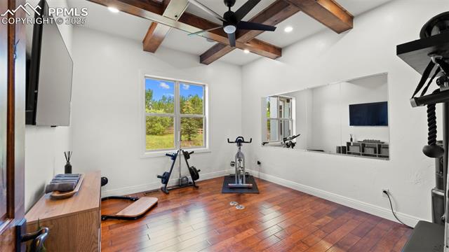 13625 Random Ridge View Colorado Springs, CO 80921 - Photo 23 of 50 Exercise area with hardwood / wood-style floors, a ceiling fan, and coffered ceiling