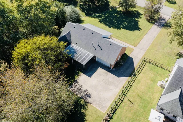 an aerial view of residential house with outdoor space and trees around