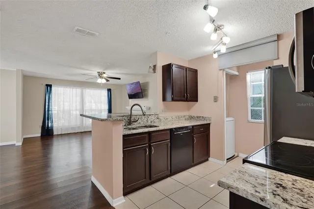 a spacious bathroom with a granite countertop sink and a mirror