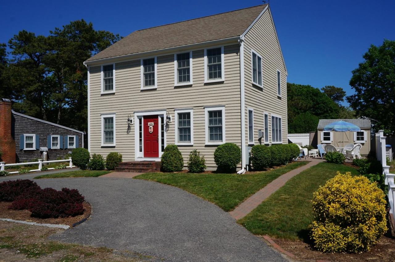 44 Longell Road Dennis Port, MA 02639 - Photo 1 of 35 a front view of a house with a yard