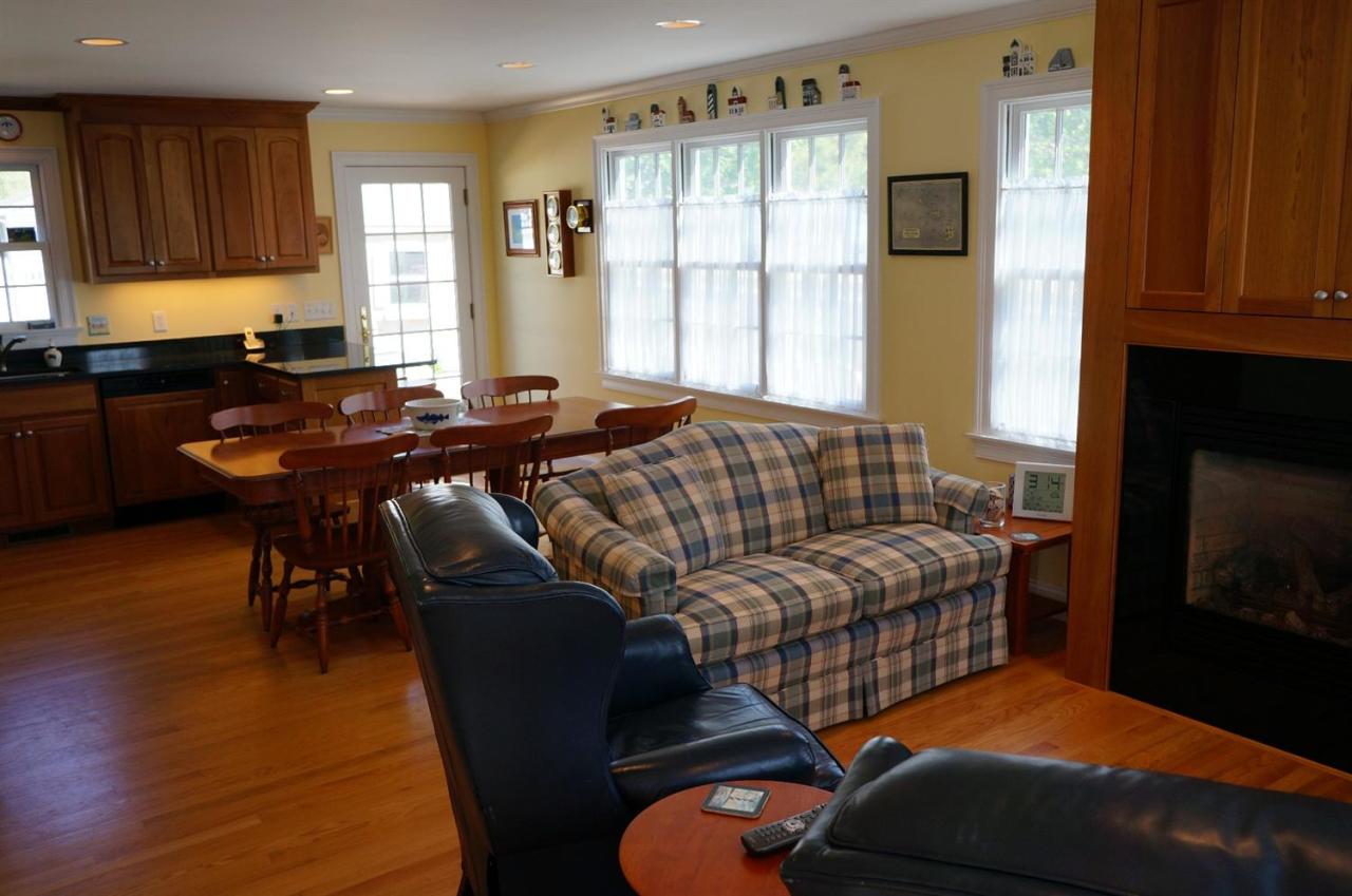 44 Longell Road Dennis Port, MA 02639 - Photo 13 of 35 a living room with furniture two windows and a fireplace