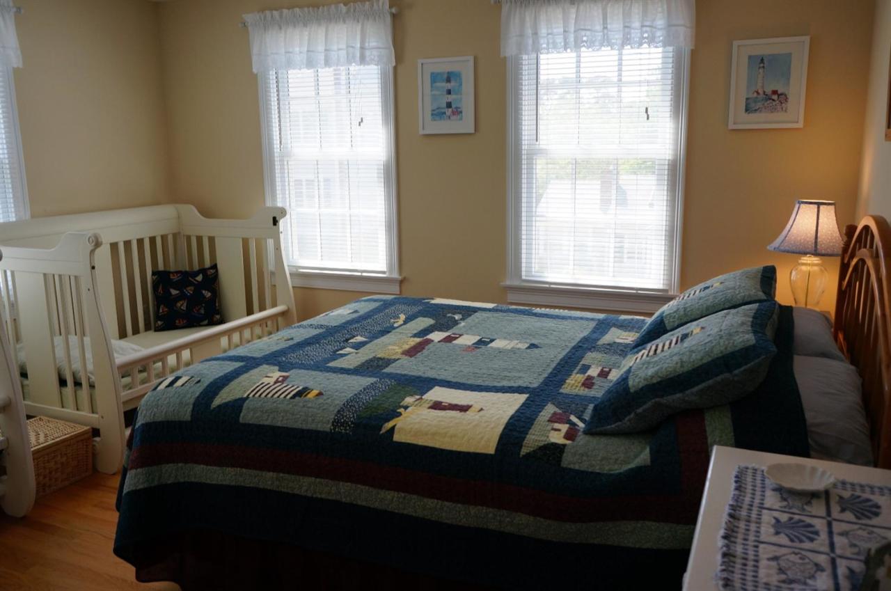 44 Longell Road Dennis Port, MA 02639 - Photo 26 of 35 a bed sitting in a bedroom next to a window