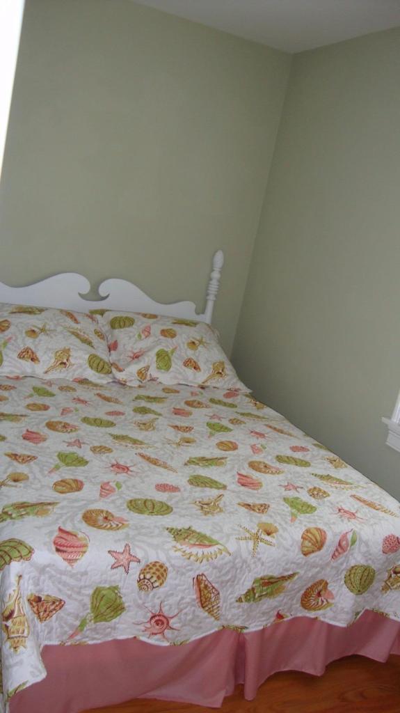 44 Longell Road Dennis Port, MA 02639 - Photo 27 of 35 a bedroom with a bed and curtain