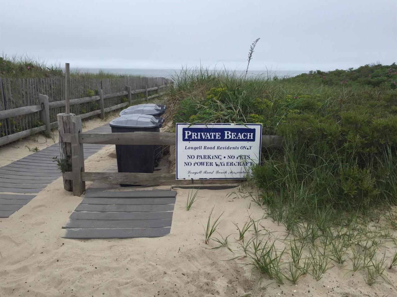 44 Longell Road Dennis Port, MA 02639 - Photo 34 of 35 a view of a bench under an umbrella