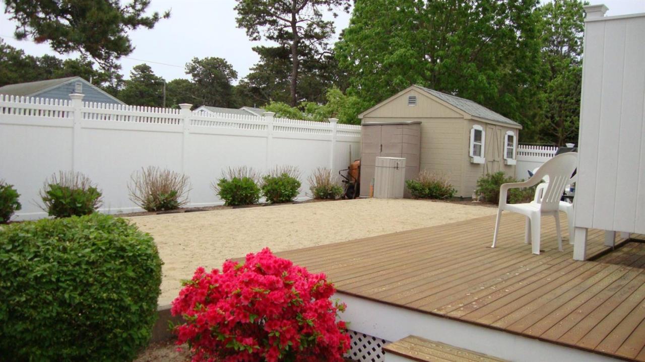 44 Longell Road Dennis Port, MA 02639 - Photo 5 of 35 a front view of a house with a yard