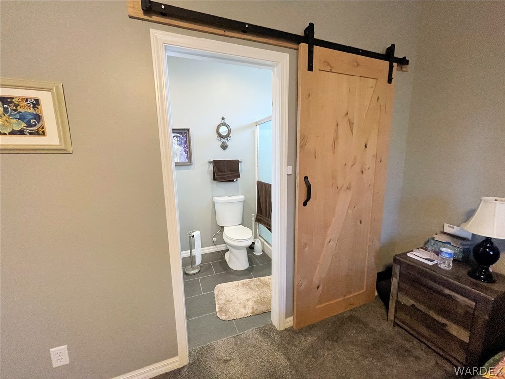 3605 North Kenneth Road Kingman, AZ 86409 - Photo 18 of 28 a bathroom with a granite countertop sink and a mirror