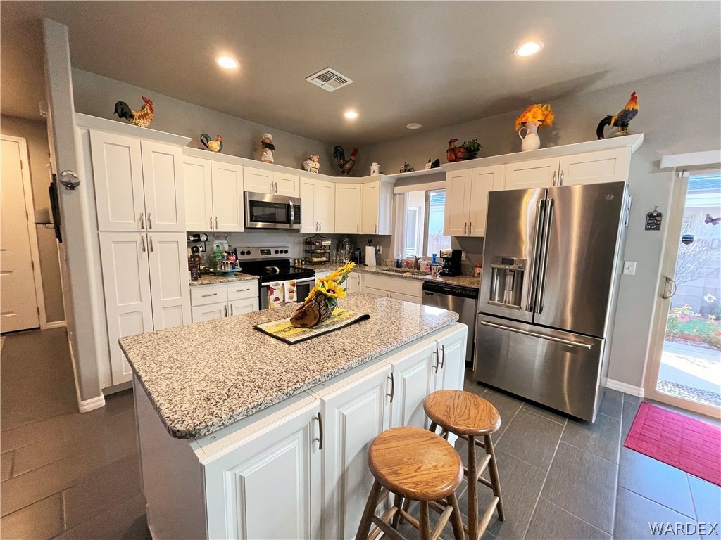3605 North Kenneth Road Kingman, AZ 86409 - Photo 9 of 28 a kitchen with stainless steel appliances granite countertop a sink refrigerator and microwave