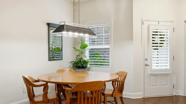 a view of a dining room with furniture and window