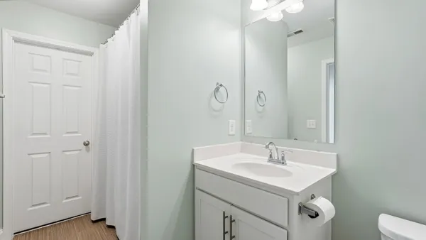 a bathroom with a sink a toilet and a mirror