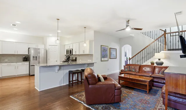 a living room with kitchen island furniture and a wooden floor