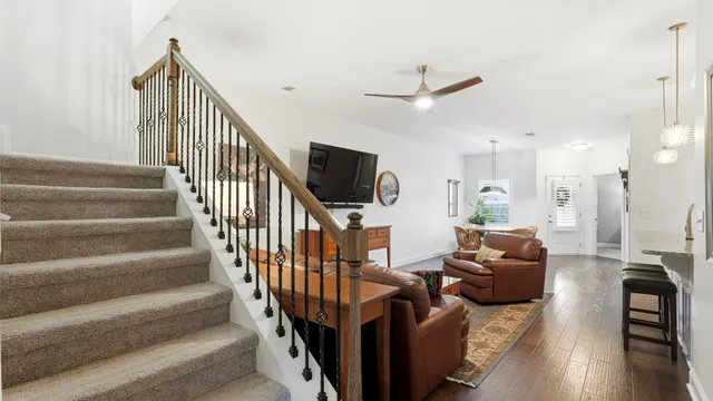 a living room with furniture or wooden floor and a flat screen tv