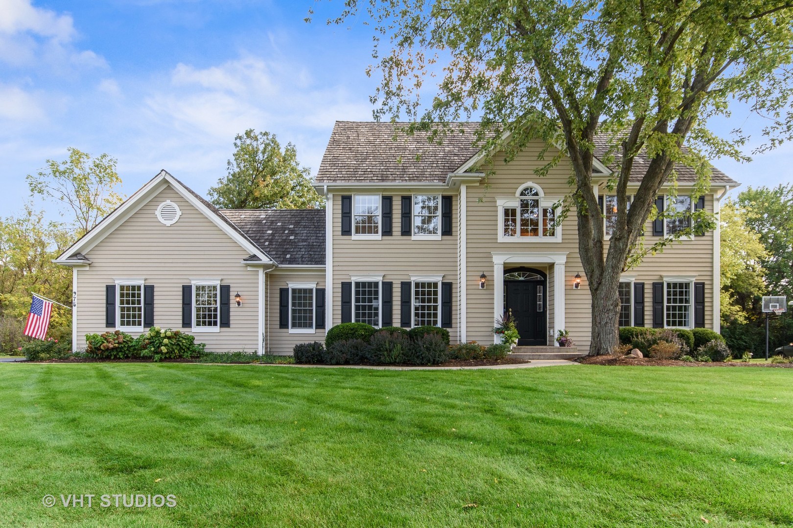 a front view of a house with a garden and plants