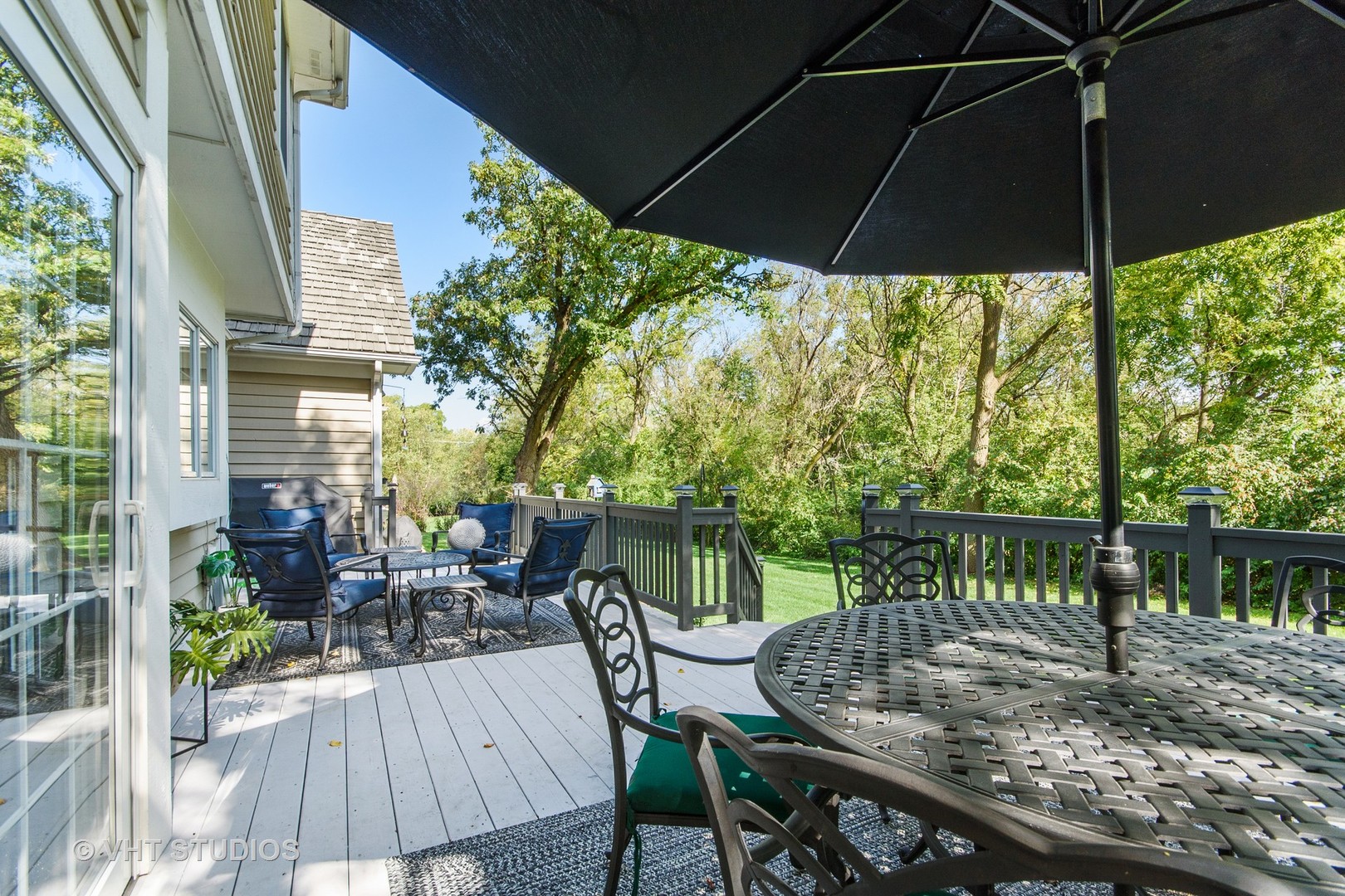 975 Prairie Hill Court Cary, IL 60013 - Photo 26 of 32 a patio with wooden floor a yard a table and chairs