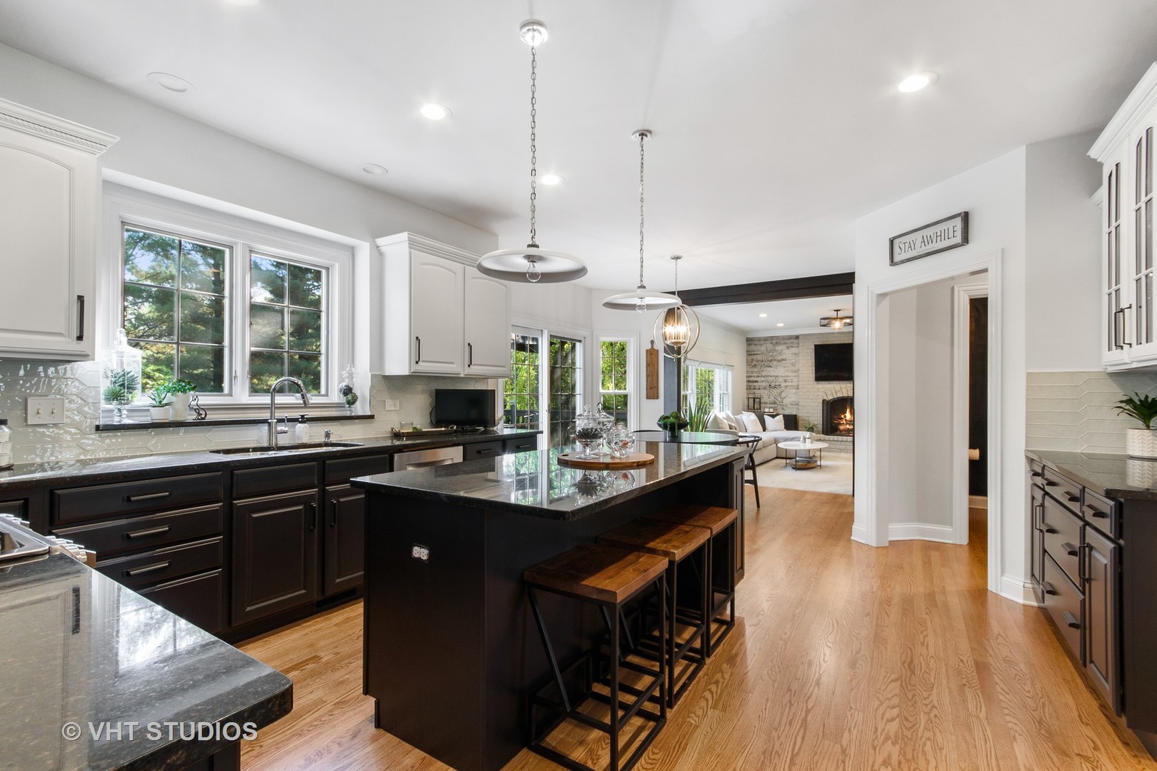 975 Prairie Hill Court Cary, IL 60013 - Photo 5 of 32 a kitchen with stainless steel appliances granite countertop a refrigerator a sink dishwasher a stove and white countertops with wooden floor