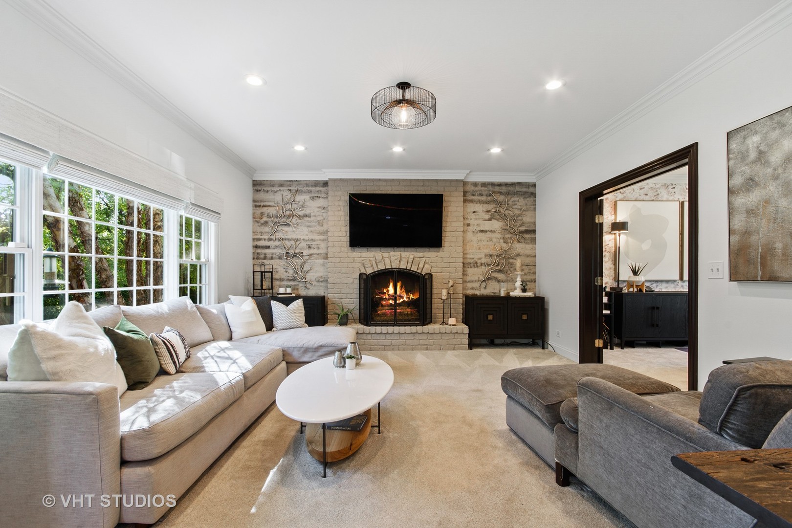975 Prairie Hill Court Cary, IL 60013 - Photo 7 of 32 a living room with furniture a fireplace and a flat screen tv