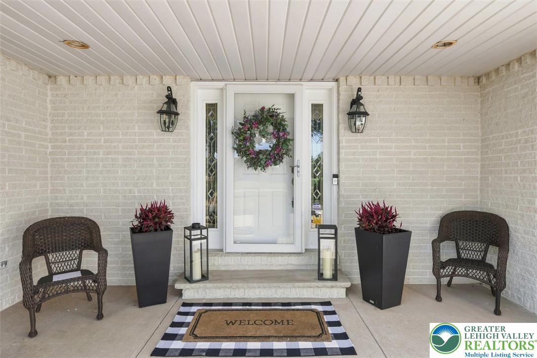 123 Meadow Road Blakeslee, PA 18610 - Photo 41 of 53 A welcoming front porch features classic brick walls and a pristine glass storm door.