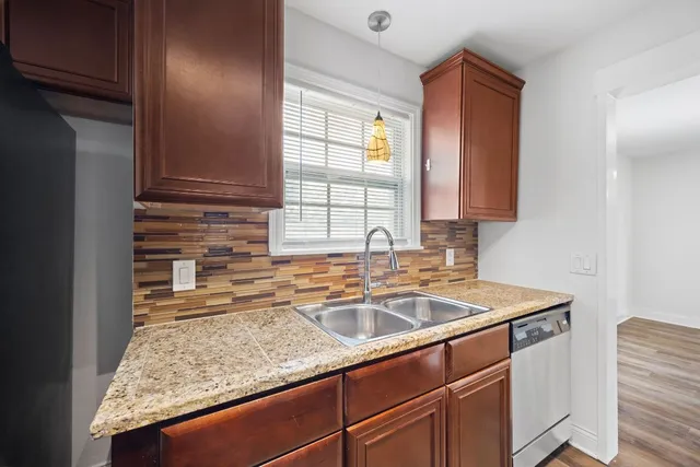 a kitchen with sink cabinets and window