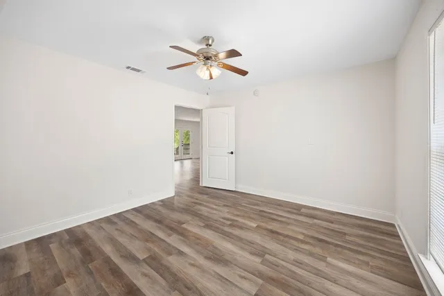 a view of a room with wooden floor and white walls