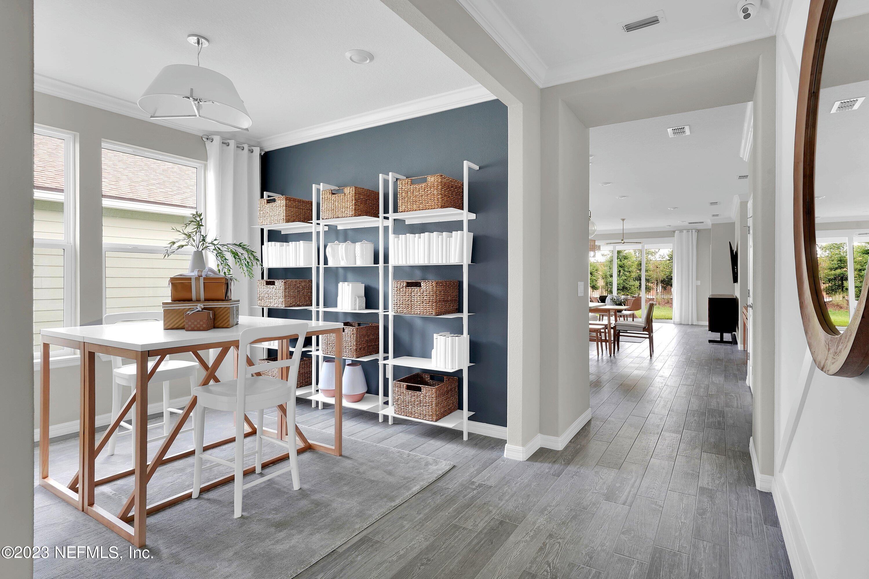 548 Jubilee Circle Yulee, FL 32097 - Photo 3 of 14 a view of a dining room with furniture window and wooden floor