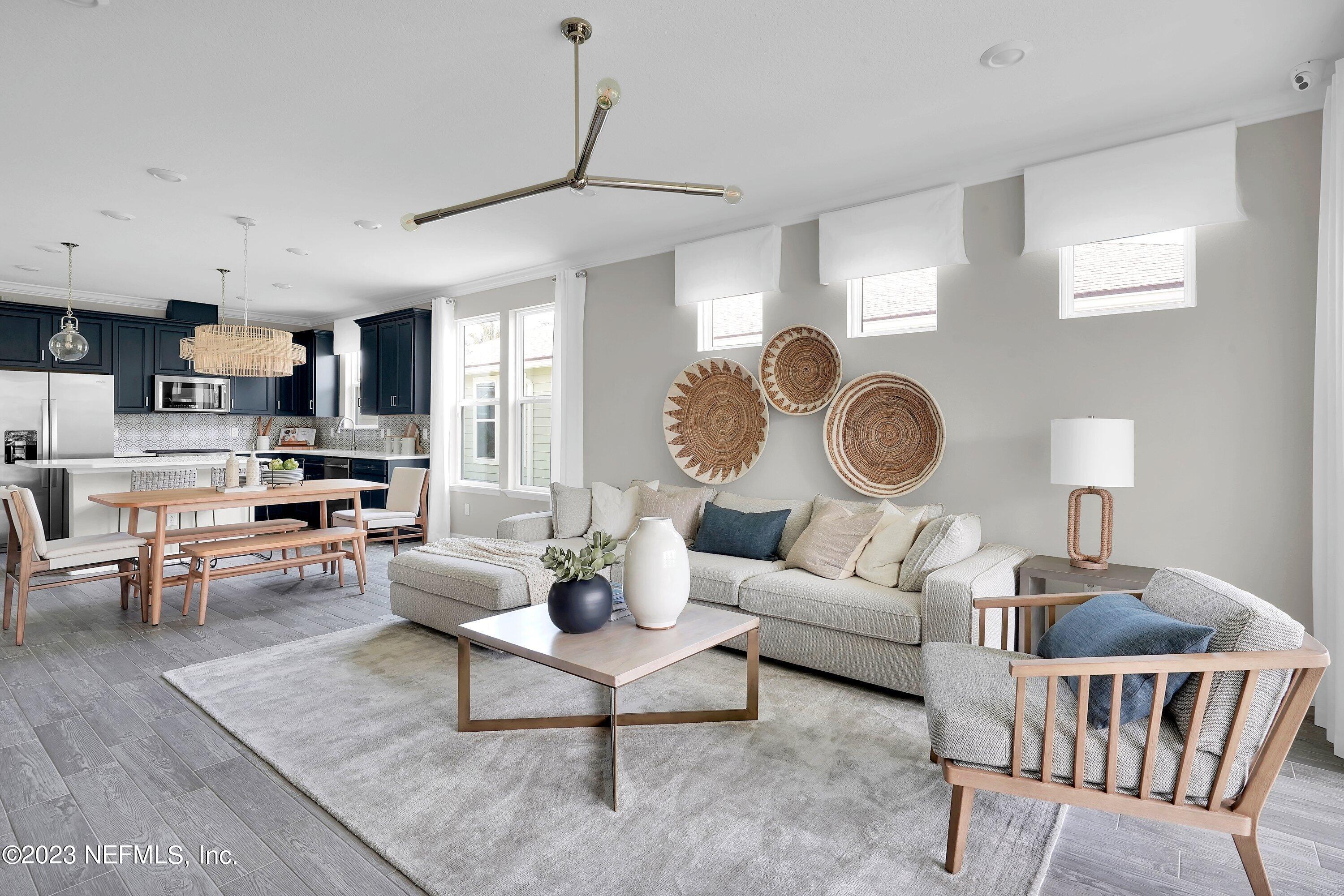 548 Jubilee Circle Yulee, FL 32097 - Photo 10 of 14 a living room with furniture a rug kitchen view and a window