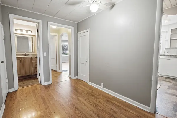 a bathroom with a granite countertop sink mirror vanity and a toilet