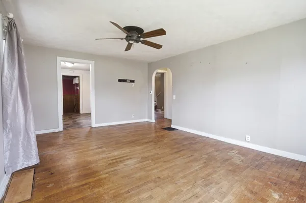 a view of a livingroom with a ceiling fan and window
