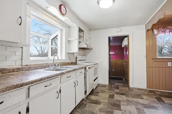 a kitchen with granite countertop a sink stainless steel appliances and cabinets