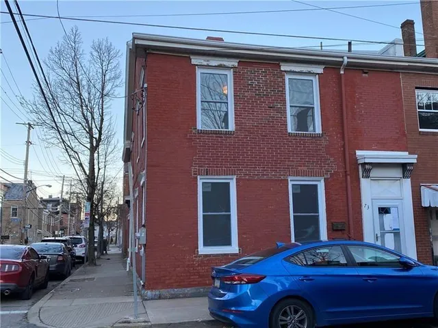 a front view of a house with parking space