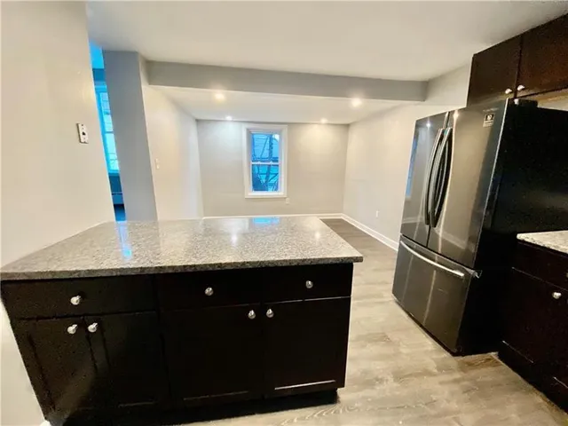 a kitchen with a sink and refrigerator