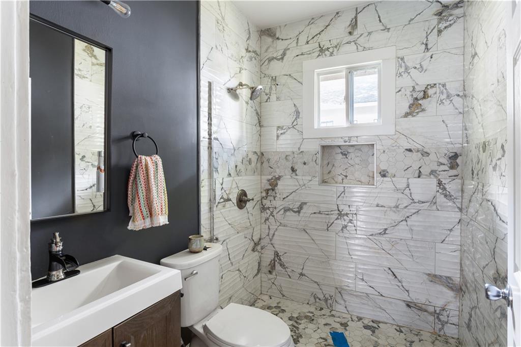 1010 Dill Avenue Southwest Atlanta, GA 30310 - Photo 17 of 39 a bathroom with a sink toilet and shower