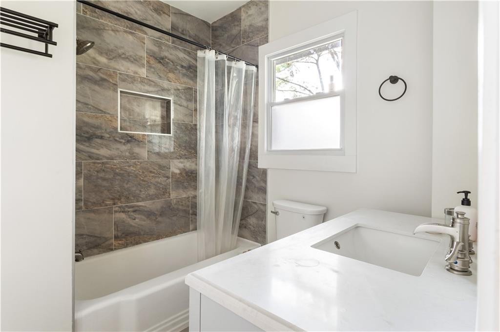 1010 Dill Avenue Southwest Atlanta, GA 30310 - Photo 21 of 39 a bathroom with a tub sink and shower