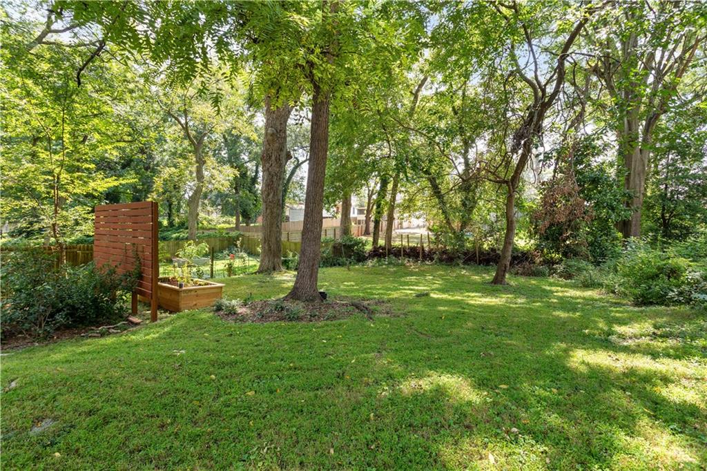 1010 Dill Avenue Southwest Atlanta, GA 30310 - Photo 27 of 39 a backyard of a house with lots of plants and large trees