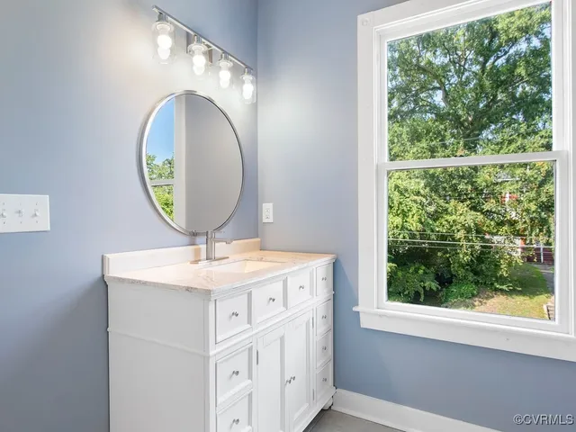 a bathroom with a sink and a mirror