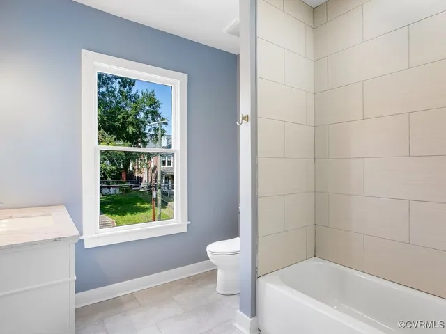 a white bath tub sitting next to a white toilet