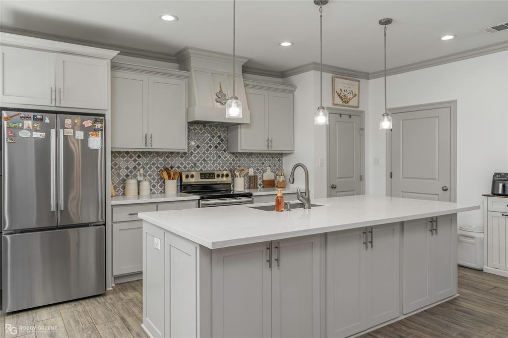 396 Collinswood Road Stonewall, LA 71078 - Photo 17 of 32 a kitchen with a refrigerator a sink and cabinets