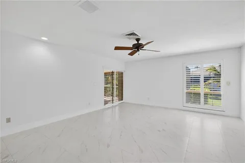 a view of room with a ceiling fan and window