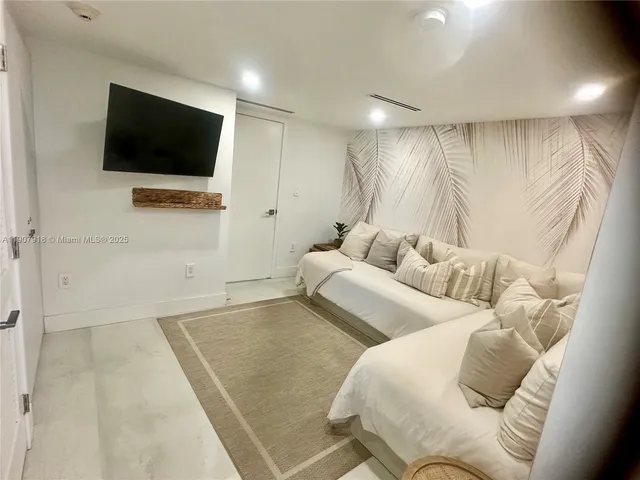 a spacious bedroom with a bed and a window