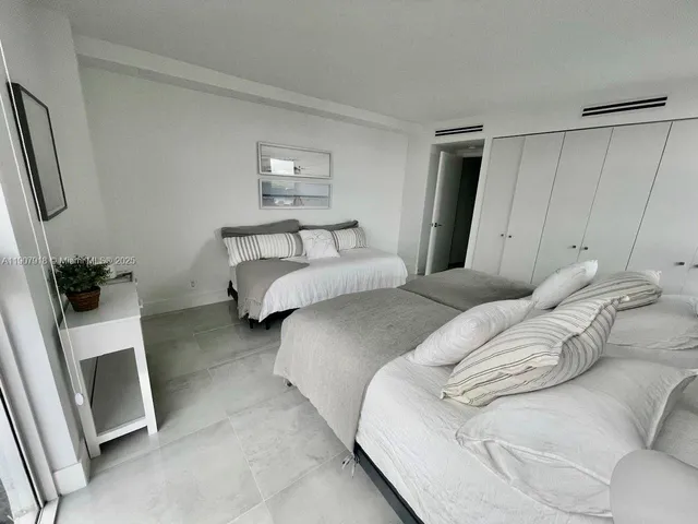 a bedroom with a bed and a mirror