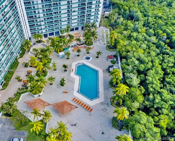a view of patio with couches and a fire pit