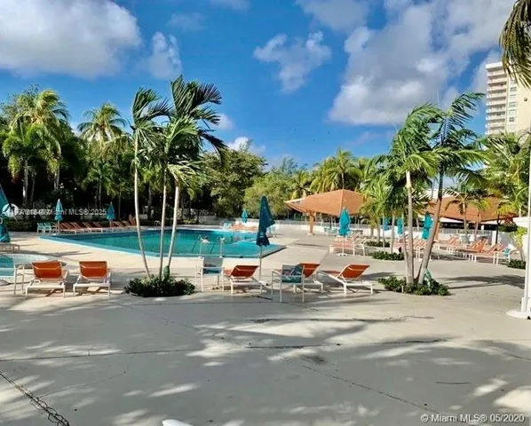a green field with trees in the background
