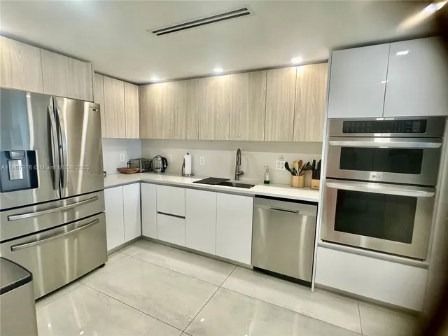 a kitchen with a refrigerator sink and microwave