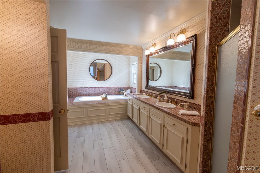 1660 Cascade Road Big Bear City, CA 92314 - Photo 15 of 42 a bathroom with a bathtub sink mirror and vanity