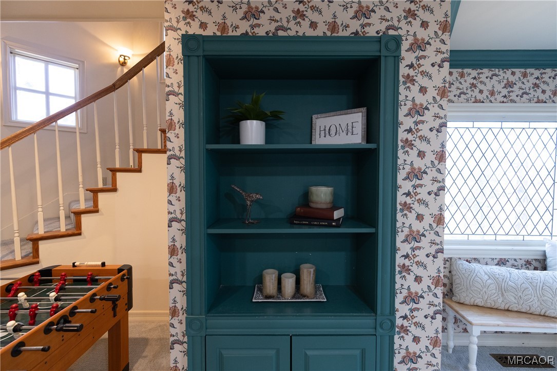 1660 Cascade Road Big Bear City, CA 92314 - Photo 26 of 42 a room with a book shelf and a wooden floor
