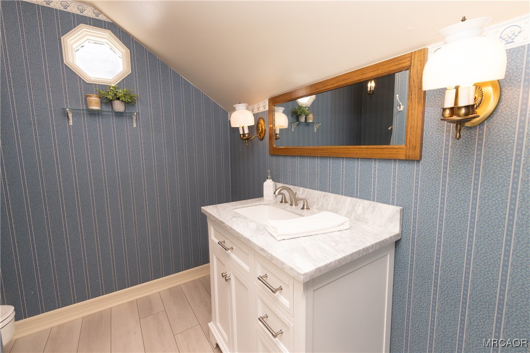 1660 Cascade Road Big Bear City, CA 92314 - Photo 32 of 42 a bathroom with a sink vanity and a mirror