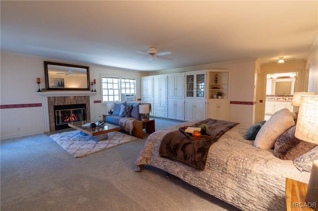 1660 Cascade Road Big Bear City, CA 92314 - Photo 7 of 42 a bedroom with furniture a fireplace and a flat screen tv